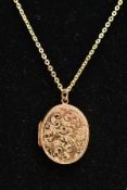 A 9CT GOLD LOCKET AND CHAIN, the locket of an oval form, foliate engraved pattern to the front,