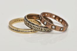 A 9CT GOLD DIAMOND RING AND TWO YELLOW METAL RINGS, the first a full eternity ring designed with