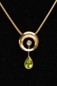AN 18CT GOLD PERIDOT AND DIAMOND PENDANT AND CHAIN, the open circular pendant with vertical pivoting