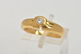 A YELLOW METAL DIAMOND RING, a domed abstract band, set with a round brilliant cut diamond, bezel