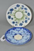 TWO MOORCROFT MACINYTRE SAUCERS FOR COFFEE CUPS, comprising a blue and white Florian ware example,