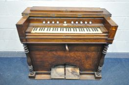 A DISTRESSED VICTORIAN WALNUT PUMP ORGAN, marked Bertheaux of Belleville Paris, width 114cm x depth