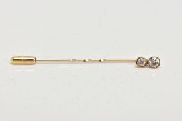 A DOUBLE DIAMOND STICK PIN, two old cut diamonds bezel set in a yellow metal, estimated total