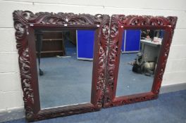 TWO LATE 20TH CENTURY FOLIATE WOODEN FRAMED AND BEVELLED EDGE WALL MIRRORS, all painted in burgundy,