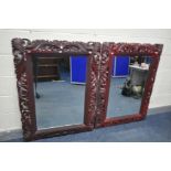 TWO LATE 20TH CENTURY FOLIATE WOODEN FRAMED AND BEVELLED EDGE WALL MIRRORS, all painted in burgundy,