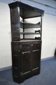 A LARGE OAK CORNER CUPBOARD, only the panelled doors are 18th century, comprising of two tiers,