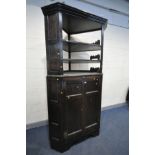 A LARGE OAK CORNER CUPBOARD, only the panelled doors are 18th century, comprising of two tiers,