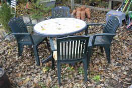 A PLASTIC CIRCULAR GARDEN TABLE and a set of four Hartman prestige plastic chairs (5)