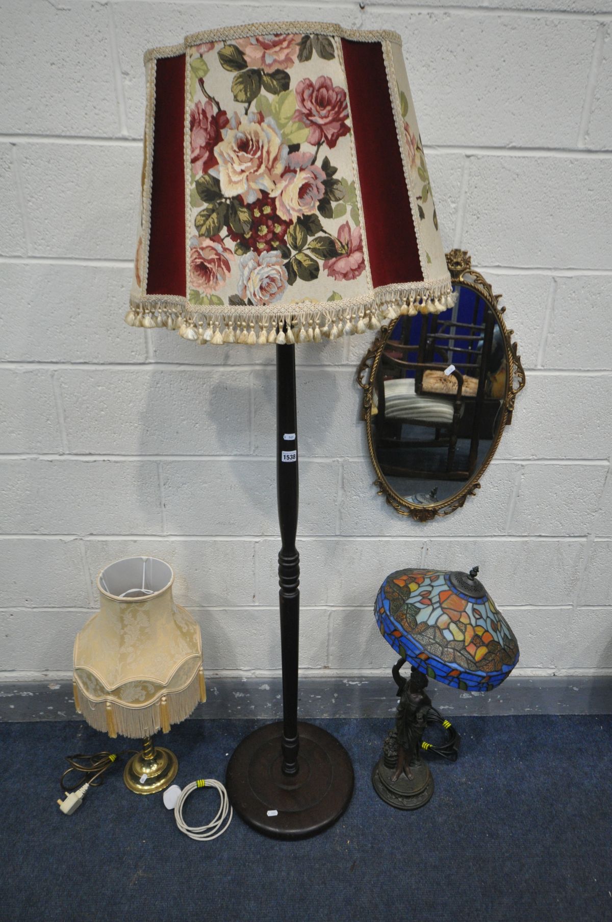 A TIFFANY STYLE FIGURAL STANDARD LAMP (condition:-broken at arm, see image) along with an ornate