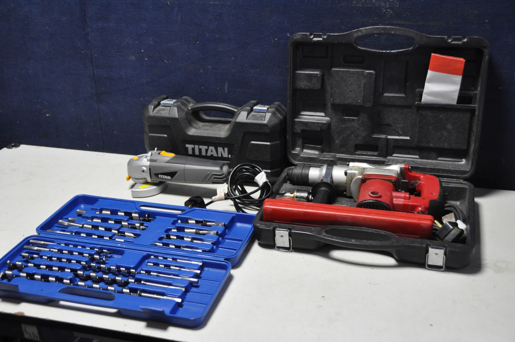 A CHAMPION CRHD850 850w rotary hammer drill in case with drill bits, a Titan TTB281GRD angle grinder