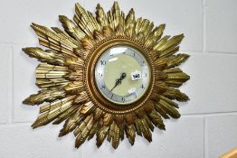 A SMITHS SUNBURST WALL CLOCK, with double sunburst and silvered dial, battery operated, not