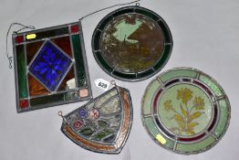 FOUR PIECES OF LEADED AND STAINED GLASS, comprising a shield shaped section decorated with