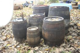 SIX COOPERED METAL BANDED BARRELS, the largest two at diameter 37cm x height 54cm together with