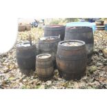 SIX COOPERED METAL BANDED BARRELS, the largest two at diameter 37cm x height 54cm together with