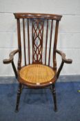 AN EDWARDIAN MAHOANY AND INLAID ELBOW CHAIR, with open fretwork central splat, scrolled armrests,