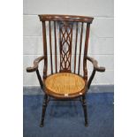 AN EDWARDIAN MAHOANY AND INLAID ELBOW CHAIR, with open fretwork central splat, scrolled armrests,