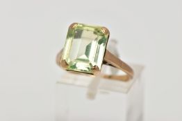 A 9CT GOLD DRESS RING, designed with a four claw set, rectangular green stone assessed as spinel,