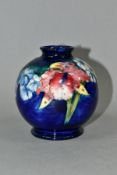 A SMALL MOORCROFT POTTERY BULBOUS VASE, Orchid pattern on blue ground, impressed backstamp and