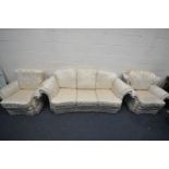 A CREAM FLORAL UPHOLSTERED THREE PIECE SUITE, comprising a three seater sofa, length 215cm, and a