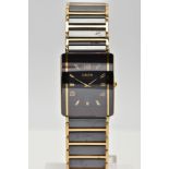 A RADO DIASTAR WATCH, black ceramic and gold tone watch with a rectangular face, gold Arabic