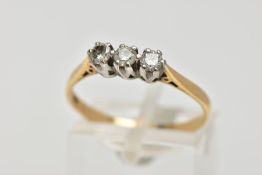 A YELLOW METAL THREE STONE DIAMOND RING, three round brilliant cut diamonds, shared claw setting,