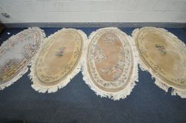 FOUR CHINESE OVAL RUGS, in three colours, 168cm x 98cm, and three various other rugs (condition:-