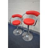 A PAIR OF STEFIX RED LEATHERETTE ADJUSTABLE HIGH STOOLS (condition - some rust spots to base)