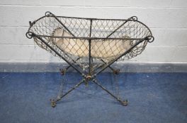 A VICTORIAN WROUGHT IRON FOLDING CHILDS COT