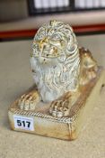 A 19TH CENTURY STONEWARE FIGURE OF A RECUMBANT LION, moulded on a rectangular plinth with rope twist