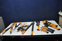 A BAG CONTAINING MOSTLY NEW FISKARS HANDTOOLS comprising of two X7 and one X11 axes, two SW75 and