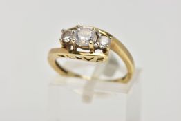 A 9CT GOLD CUBIC ZIRCONIA THREE STONE RING, designed with three colourless, circular cut cubic