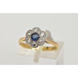 AN 18CT GOLD SAPPHIRE AND DIAMOND CLUSTER RING, of a flower shape, centring on a circular cut blue