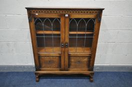 A MELLOWCRAFT OAK LEAD GLAZED DOUBLE DOOR BOOKCASE, with two adjustable shelves, width 97cm x