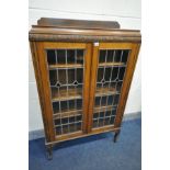 AN EARLY 20TH CENTURY OAK LEAD GLAZED TWO DOOR BOOKCASE, with three adjustable shelves, width 91cm x