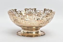 A PIERCED WHITE METAL BOWL, of a circular form, pierced decorations to the rim, raised on a wavy rim