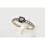 A WHITE METAL CUBIC ZIRCONIA RING, designed with a central four claw set, circular cut black cubic