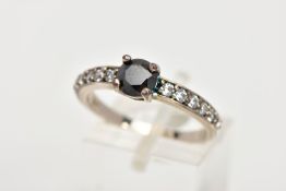 A WHITE METAL CUBIC ZIRCONIA RING, designed with a central four claw set, circular cut black cubic