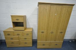 A PINE EFFECT BEDROOM SUITE, comprising a triple door wardrobe, width 120cm x depth 54cm x height