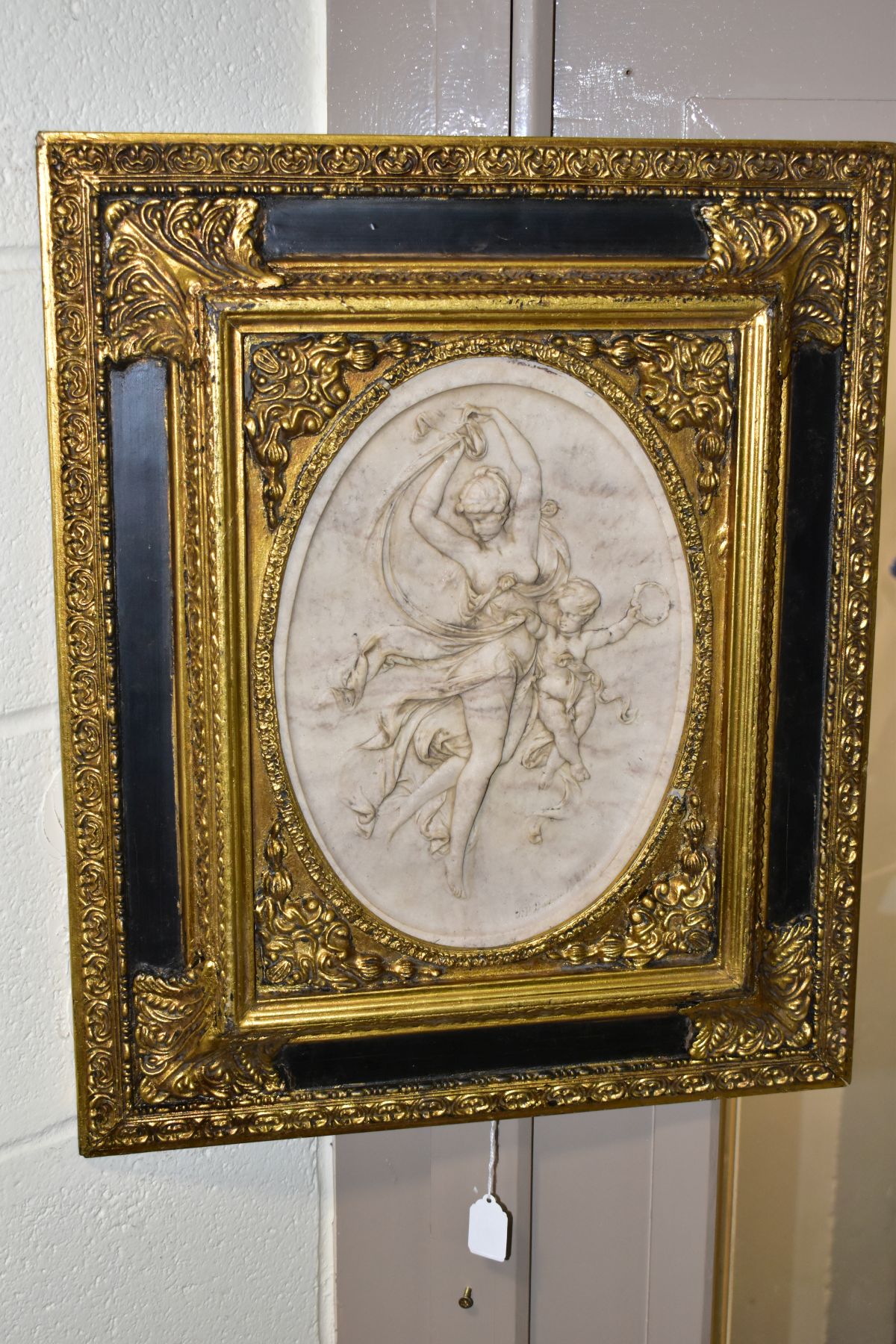 AFTER T P DANBIERE, A HIGH RELIEF CAST MARBLE PLAQUE, depicting a scantily clad female figure and