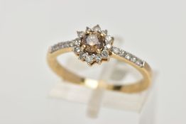 A 9CT GOLD DIAMOND CLUSTER RING, centring on a brown round brilliant cut diamond, within a