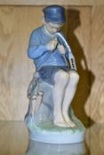 A ROYAL COPENHAGEN FIGURE OF A BOY WHITTLING A STICK, The Wittler no 905 height 18cm, with printed