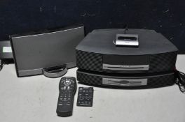 A BOSE WAVE MUSIC SYSTEM with Bose disc changer (faulty) and remote along with a Bose sound dock (
