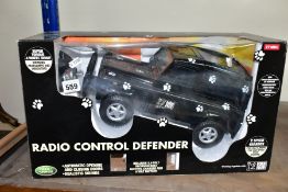 A BOXED RADIO CONTROLLED LAND ROVER DEFENDER, black Born Free edition, in original packaging with