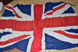 A VERY LARGE UNION FLAG, measuring approximately 128cm x 548cm, with loops for hanging (Condition