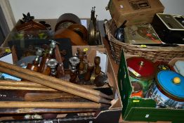 THREE BOXES AND A WICKER BASKET OF CLOCKS, TINS, TREEN CANDLESTICKS, CRICKETING EQUIPMENT, ETC,