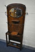 AN 1930'S/40'S OAK HALL STAND with Art Nouveau coat hooks surrounding an oval mirror, width 69cm x