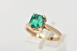 A 9CT GOLD SYNTHETIC EMERALD RING, desinged with a square cut synthetic emerald with cut off