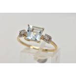 A 9CT GOLD AQUAMARINE RING, centring on a four claw set, square cut aquamarine, to colourless spinel