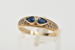 A 9CT GOLD SAPPHIRE AND DIAMOND RING, set with two pear cut blue sapphires, each collet mounted,