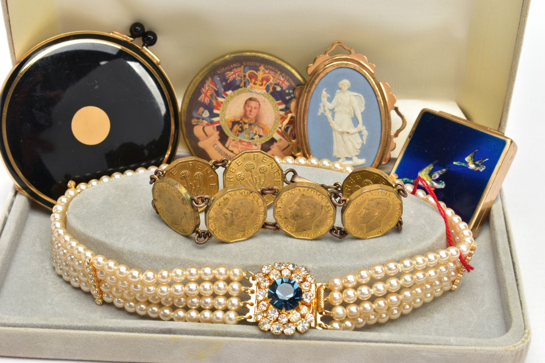 A TRAY OF ASSORTED ITEMS, to include a boxed imitation pearl necklace fitted with a yellow metal